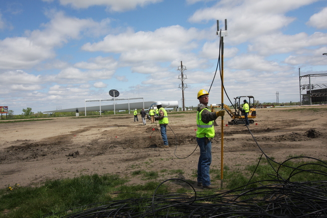 Crew workers using Figure 8 Fork to keep cable from getting tangled.