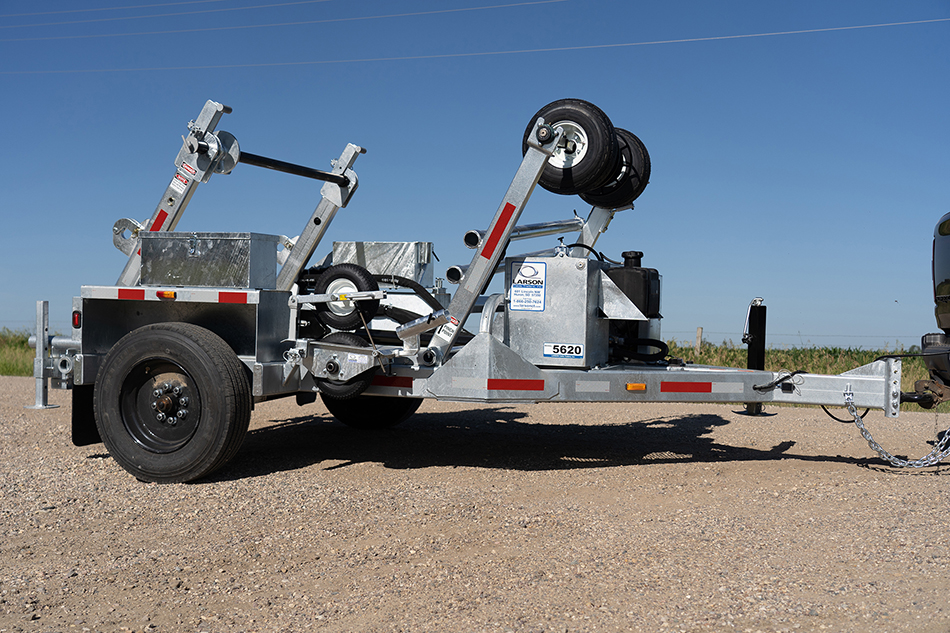 LCT-5620 trencher positioned on a road, next to a grassy area.