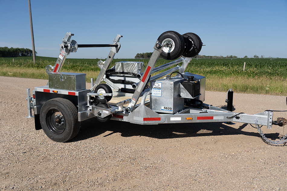 A high-angle view of a worker with a LCT-5620 trencher on a street.
