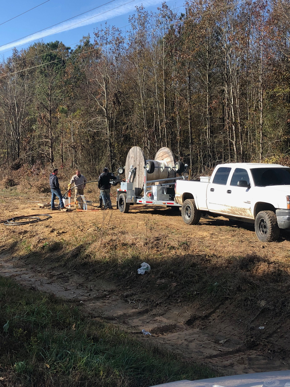 LCT-5620 on worksite, pulled by white pickup truck.