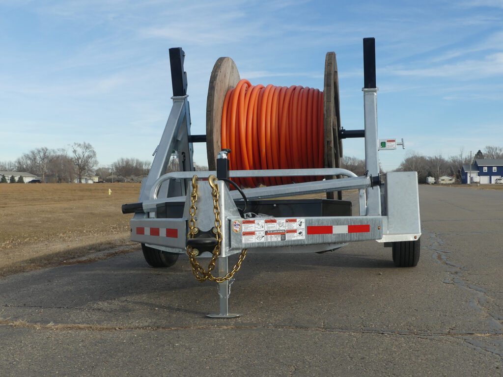 A galvanized LCT 7500 reel trailer and an LRT 8R combo trailer positioned together on a clear day.