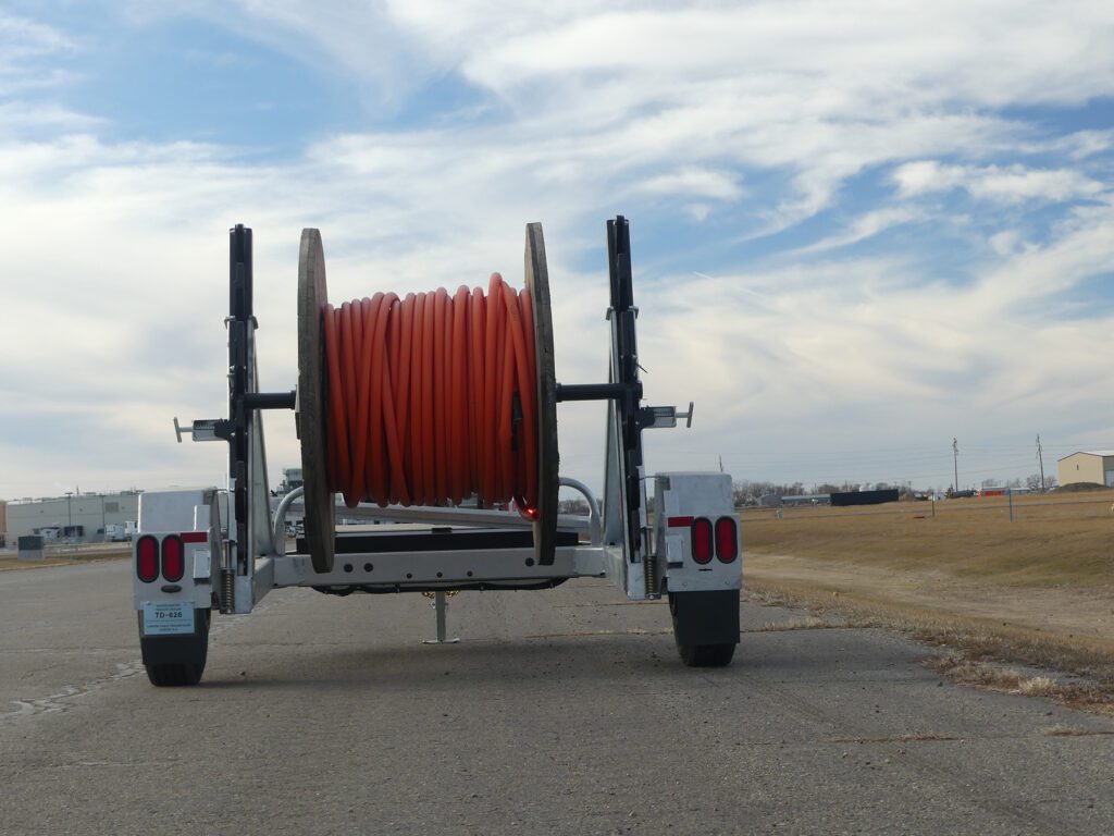Heavy machinery for telecom and power, the Larson LCT 7500 and LRT 8R, in a field.